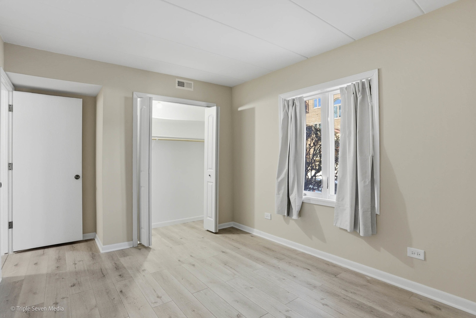 17236 Ridgeland Avenue, Unit 412 Tinley Park, IL 60477 - Photo 14 of 23 an empty room with wooden floor and windows