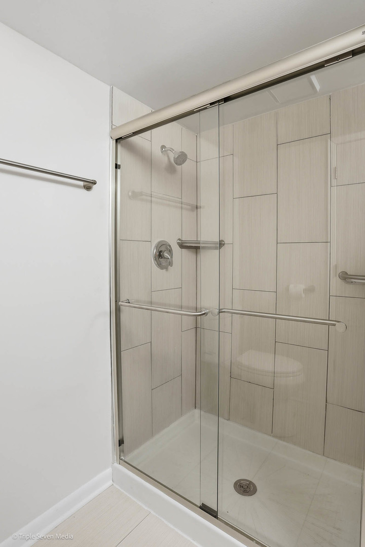 17236 Ridgeland Avenue, Unit 412 Tinley Park, IL 60477 - Photo 19 of 23 a bathroom with a shower