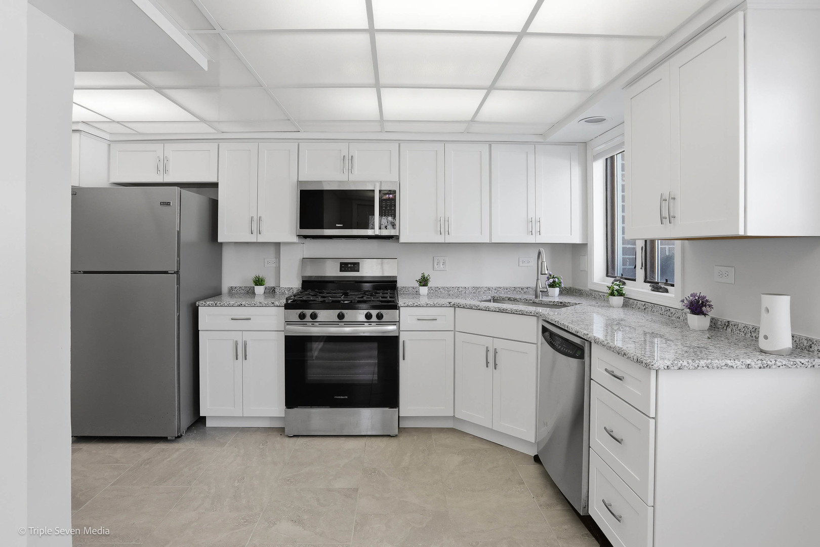 17236 Ridgeland Avenue, Unit 412 Tinley Park, IL 60477 - Photo 2 of 23 a kitchen with stainless steel appliances granite countertop a refrigerator sink stove microwave and cabinets