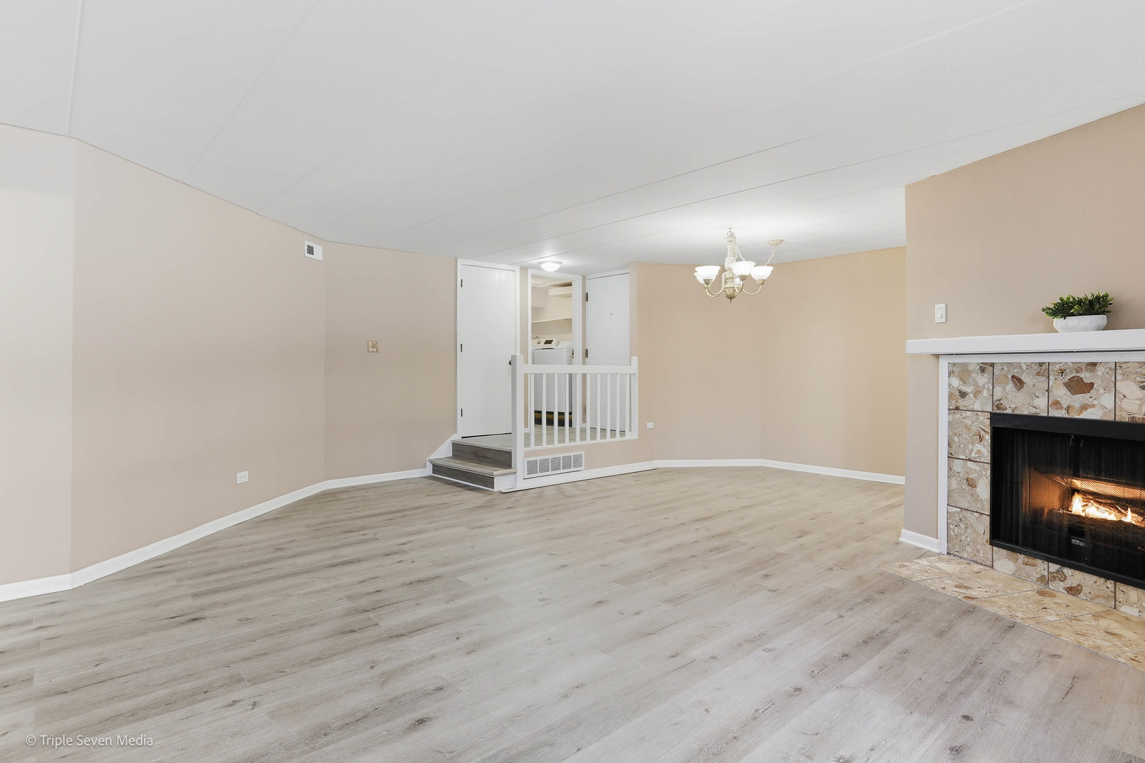 17236 Ridgeland Avenue, Unit 412 Tinley Park, IL 60477 - Photo 6 of 23 a view of empty room with wooden floor and fireplace
