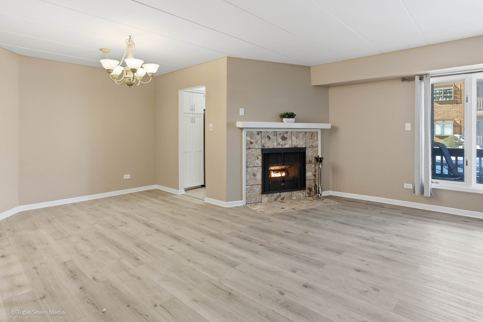 17236 Ridgeland Avenue, Unit 412 Tinley Park, IL 60477 - Photo 7 of 23 a view of empty room with fireplace and wooden floor