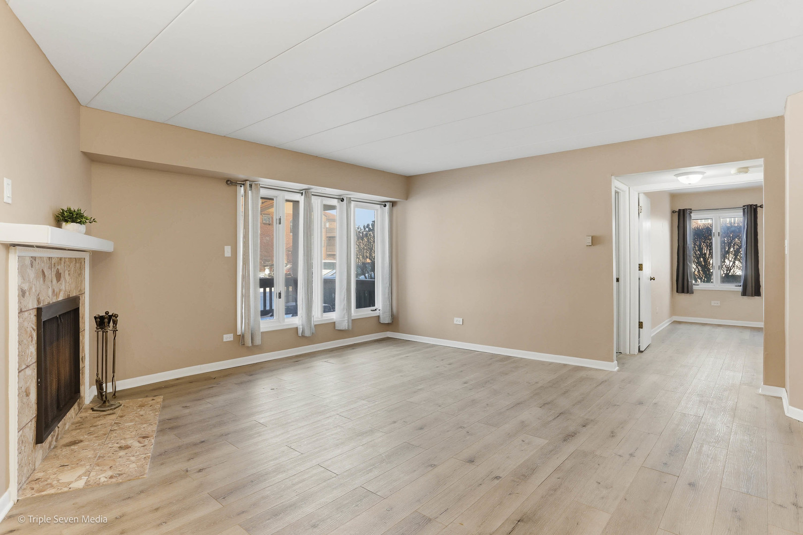 17236 Ridgeland Avenue, Unit 412 Tinley Park, IL 60477 - Photo 8 of 23 wooden floor fireplace and windows in an empty room