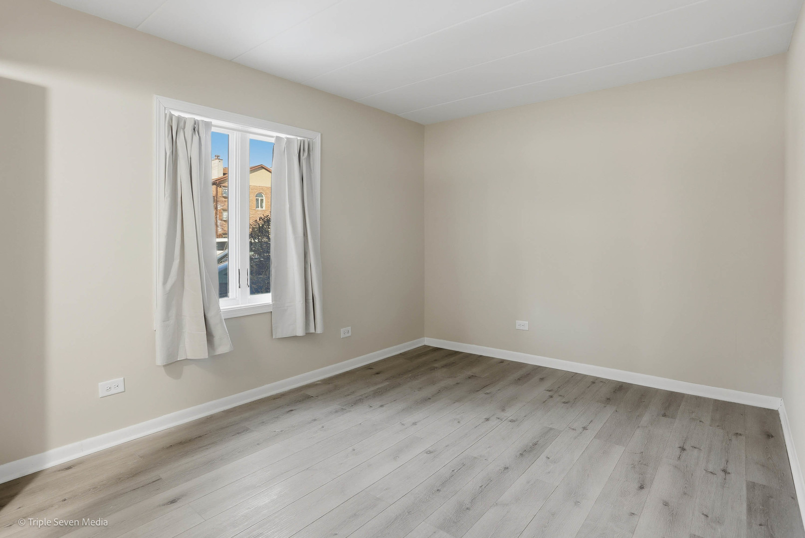 17236 Ridgeland Avenue, Unit 412 Tinley Park, IL 60477 - Photo 10 of 23 an empty room with wooden floor and door