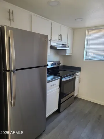 a white refrigerator freezer sitting inside of a kitchen