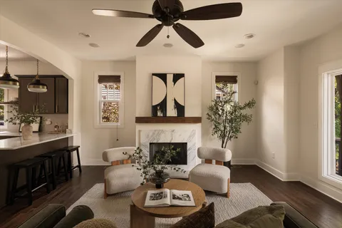 a living room with furniture a fireplace and a window