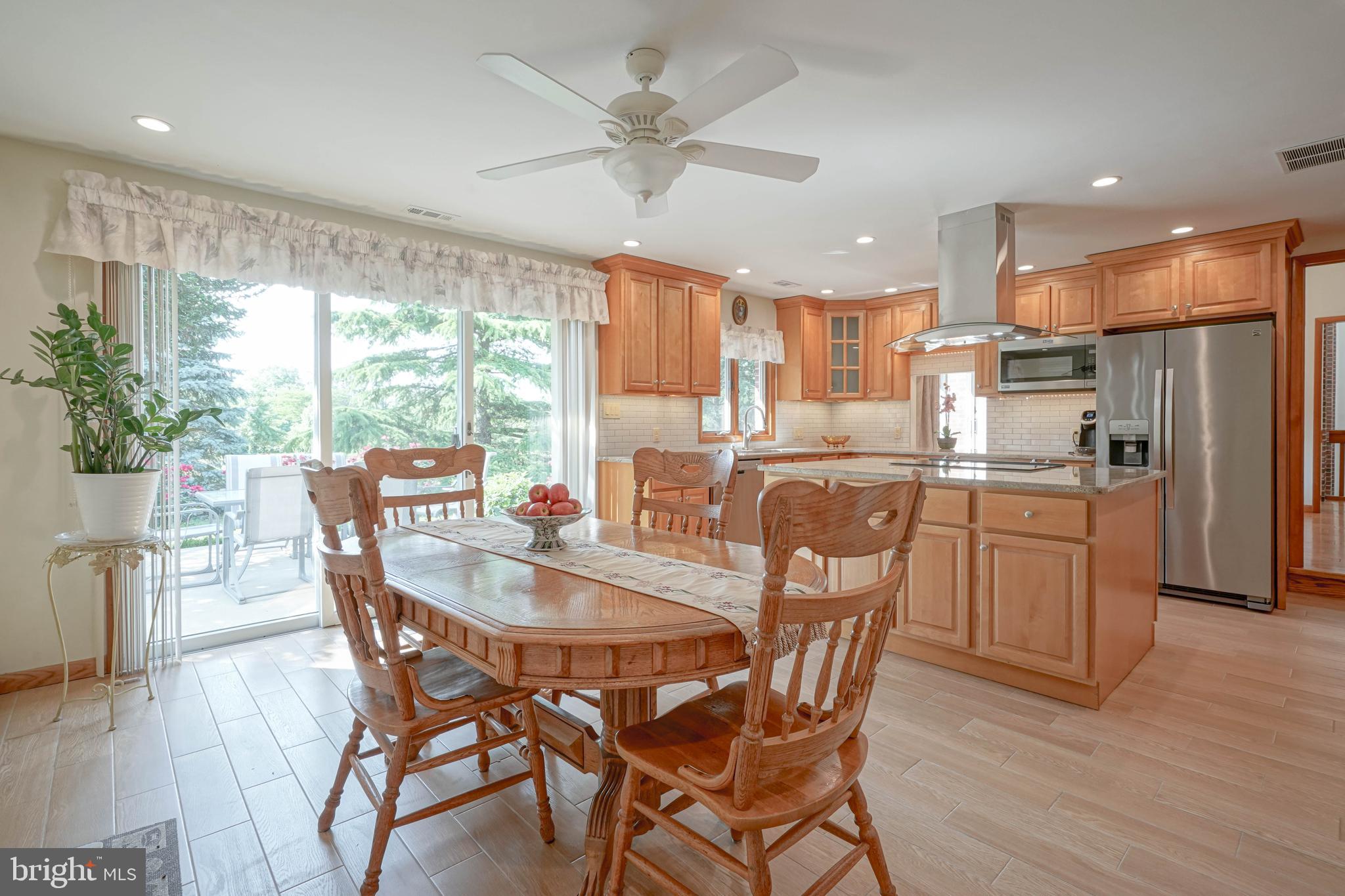 664 Union Road Mickleton, NJ 08056 - Photo 15 of 40 a kitchen with stainless steel appliances granite countertop a dining table chairs refrigerator and sink