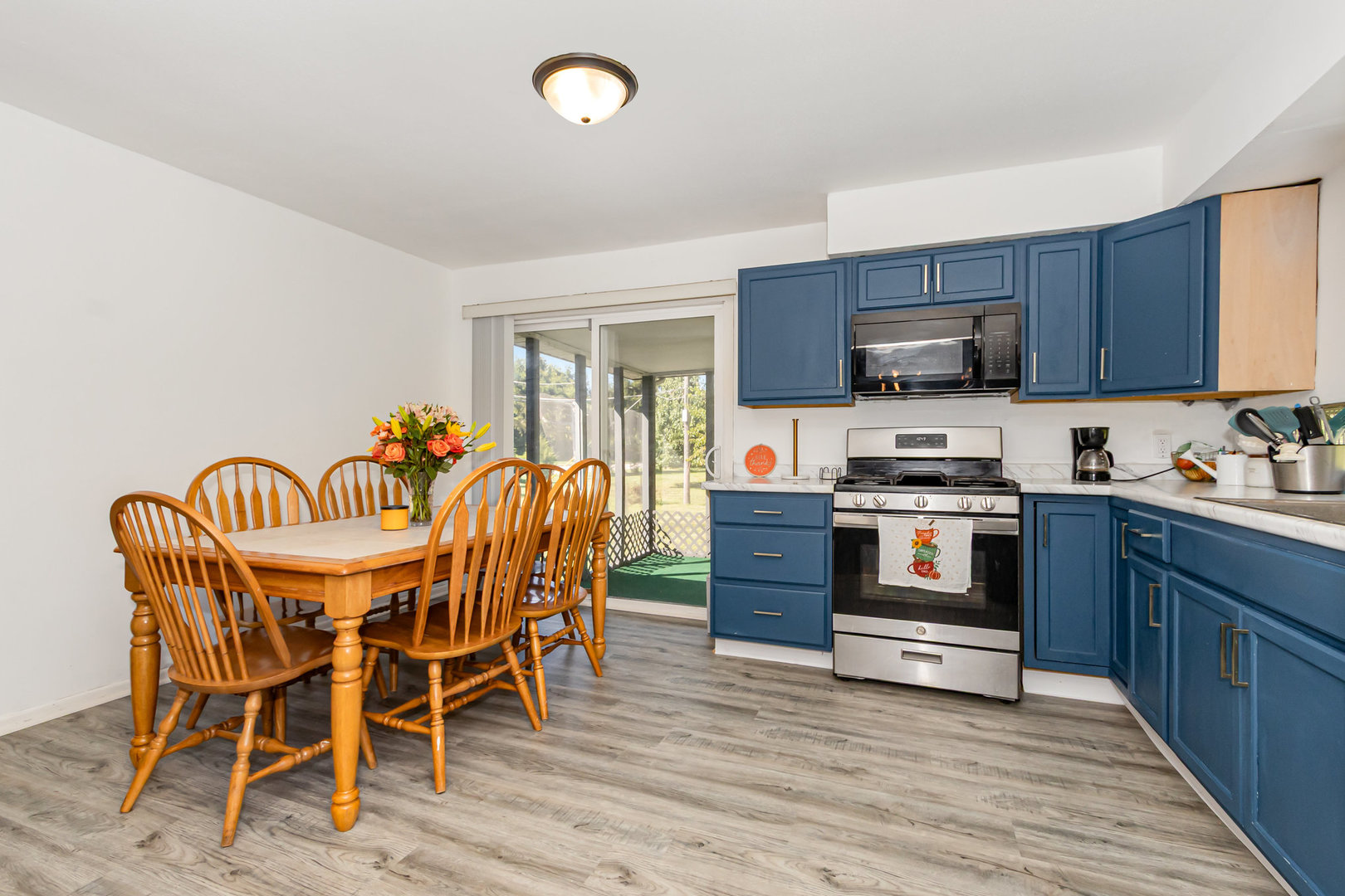 2535 Caton Farm Road Joliet, IL 60435 - Photo 14 of 25 a kitchen with stainless steel appliances kitchen island granite countertop a dining table chairs and granite counter tops