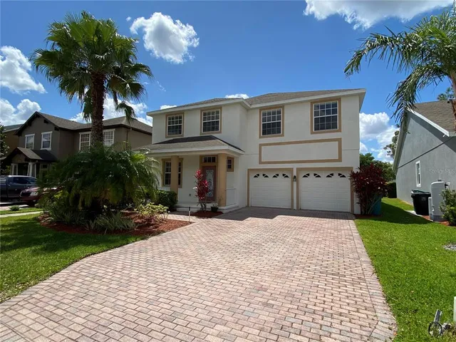 a front view of house with yard and green space