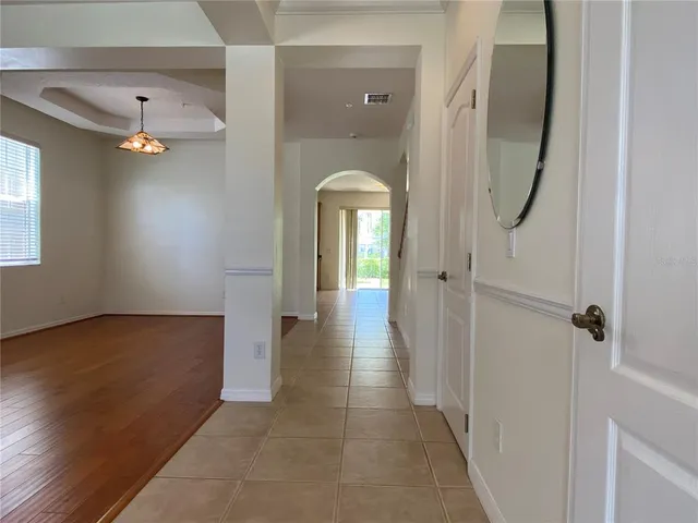 a view of a hallway with wooden floor and staircase