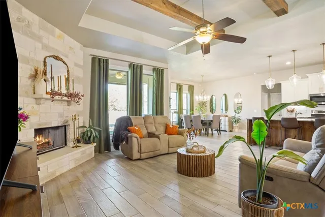 a living room with furniture fireplace and a chandelier