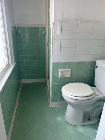 a white toilet sitting next to a bathroom sink