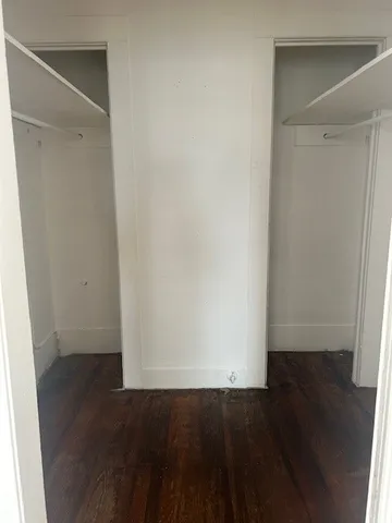 an empty room with wooden floor