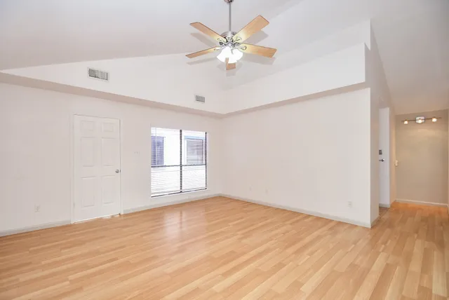 wooden floor in an empty room with a window