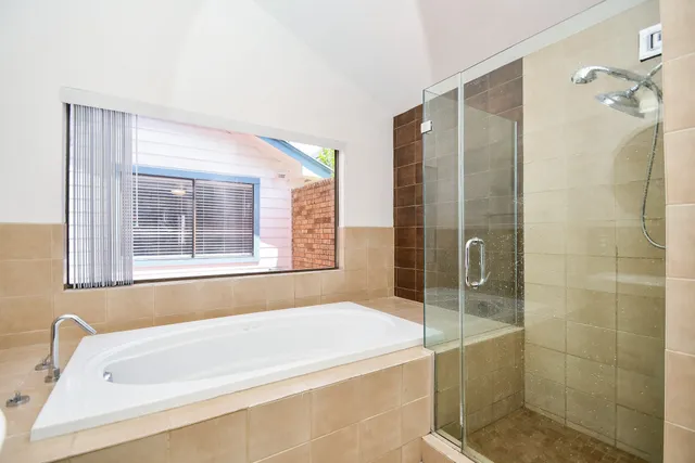 a bathroom with a bathtub and shower