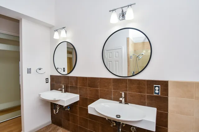 a bathroom with a sink a mirror and a toilet