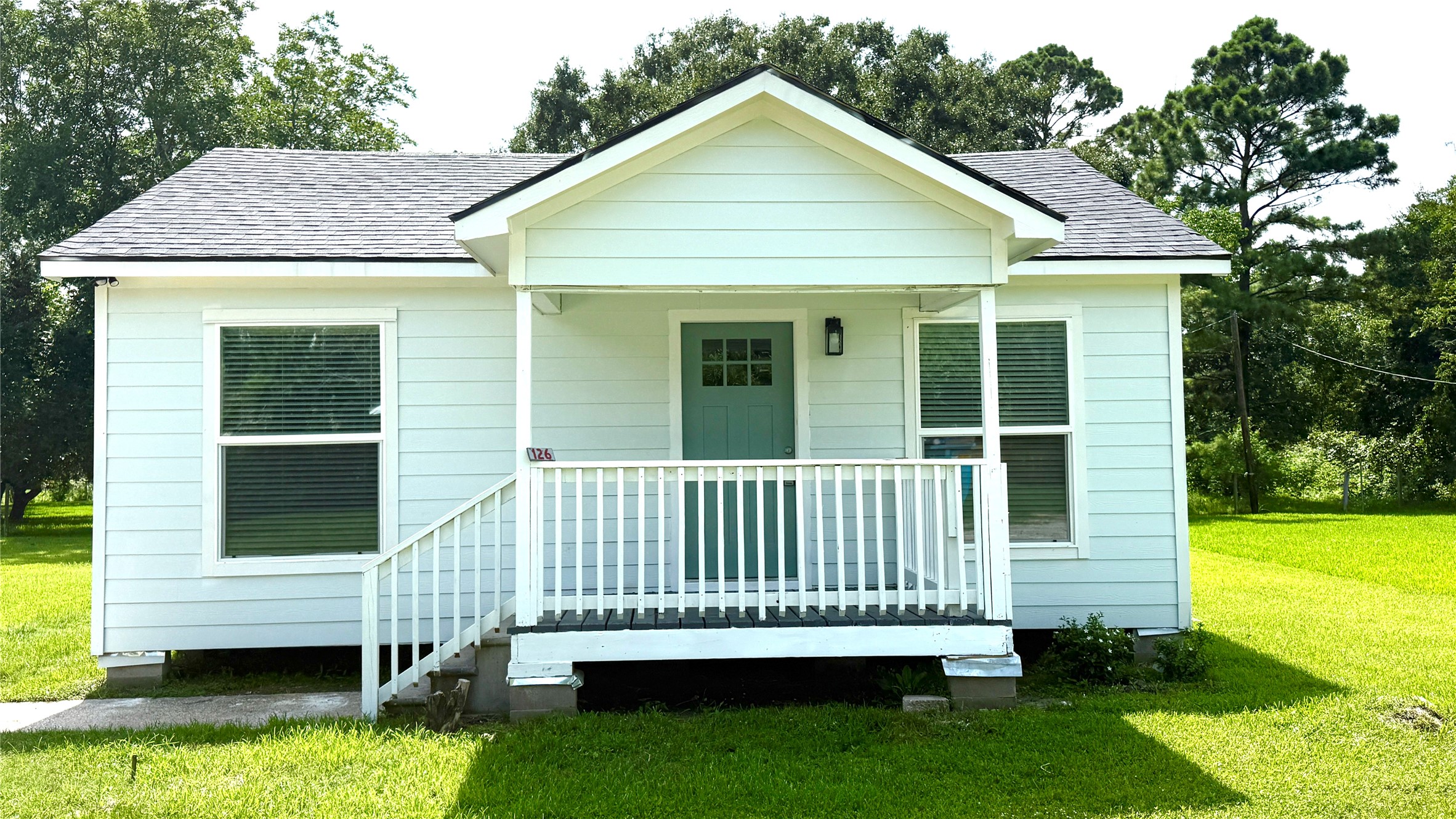 a view of a house with a yard and a garden