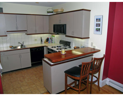 15 Claflin Road, Unit 1 Brookline, MA 02445 - Photo 5 of 13 a kitchen with a sink cabinets and wooden floor