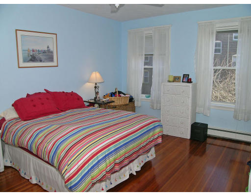 15 Claflin Road, Unit 1 Brookline, MA 02445 - Photo 8 of 13 a bedroom with a bed and a lamp on dresser