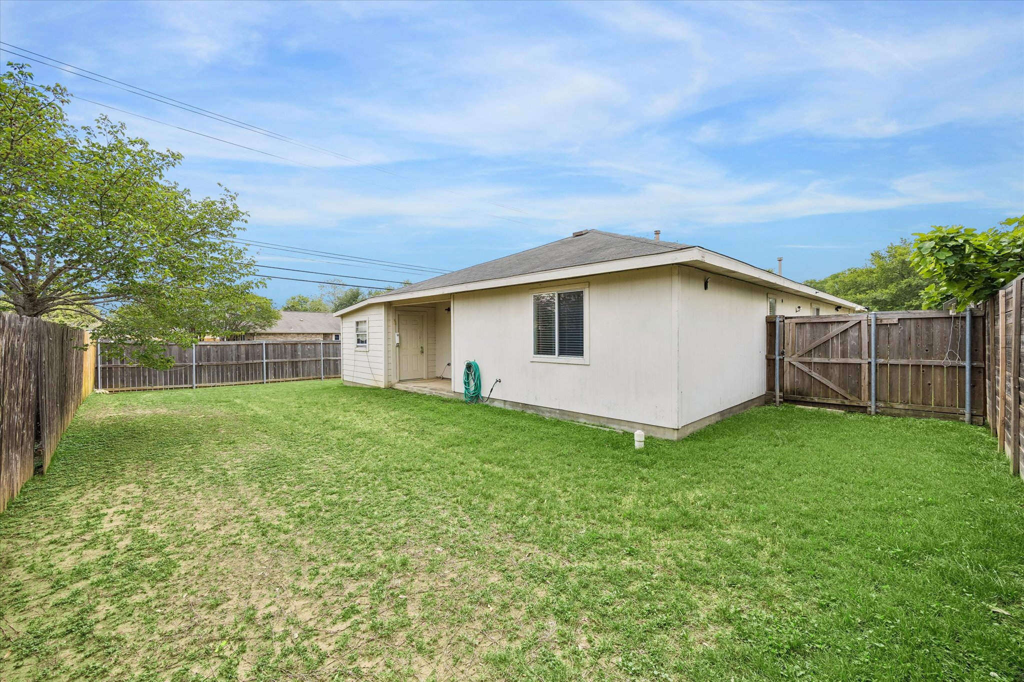 14410 Sandifer Street Austin, TX 78725 - Photo 3 of 10 a view of a backyard with plants and large trees