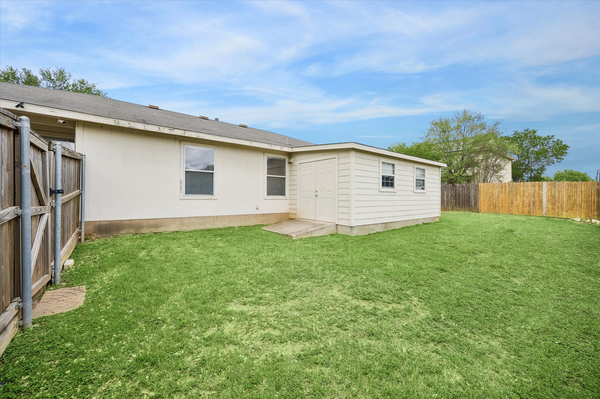 14410 Sandifer Street Austin, TX 78725 - Photo 4 of 10 a view of a backyard with garage
