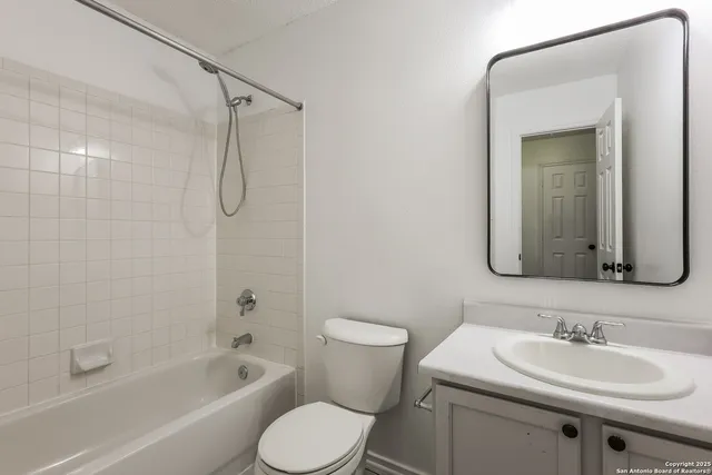 a bathroom with a sink toilet tub vanity and shower