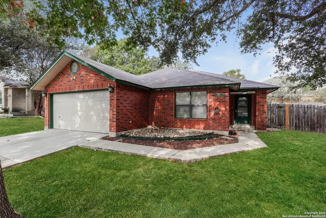 a front view of a house with a garden and yard