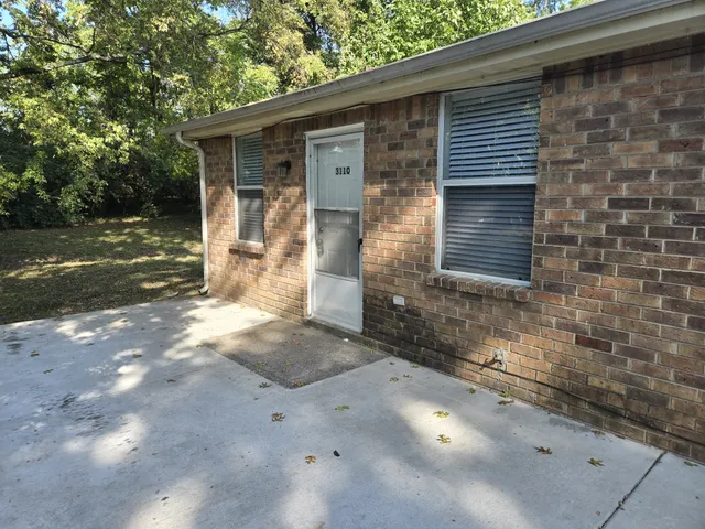 a view of a small house with yard
