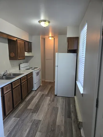 a kitchen with a refrigerator a sink and cabinets