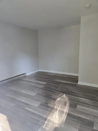 a view of room with wooden floor
