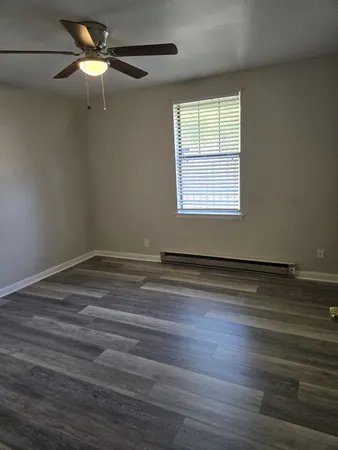 wooden floor in an empty room with a window