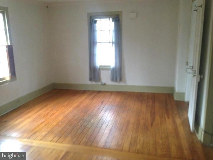 1 Breakneck Road, Unit 4 Medford, NJ 08055 - Photo 4 of 8 an empty room with wooden floor and windows
