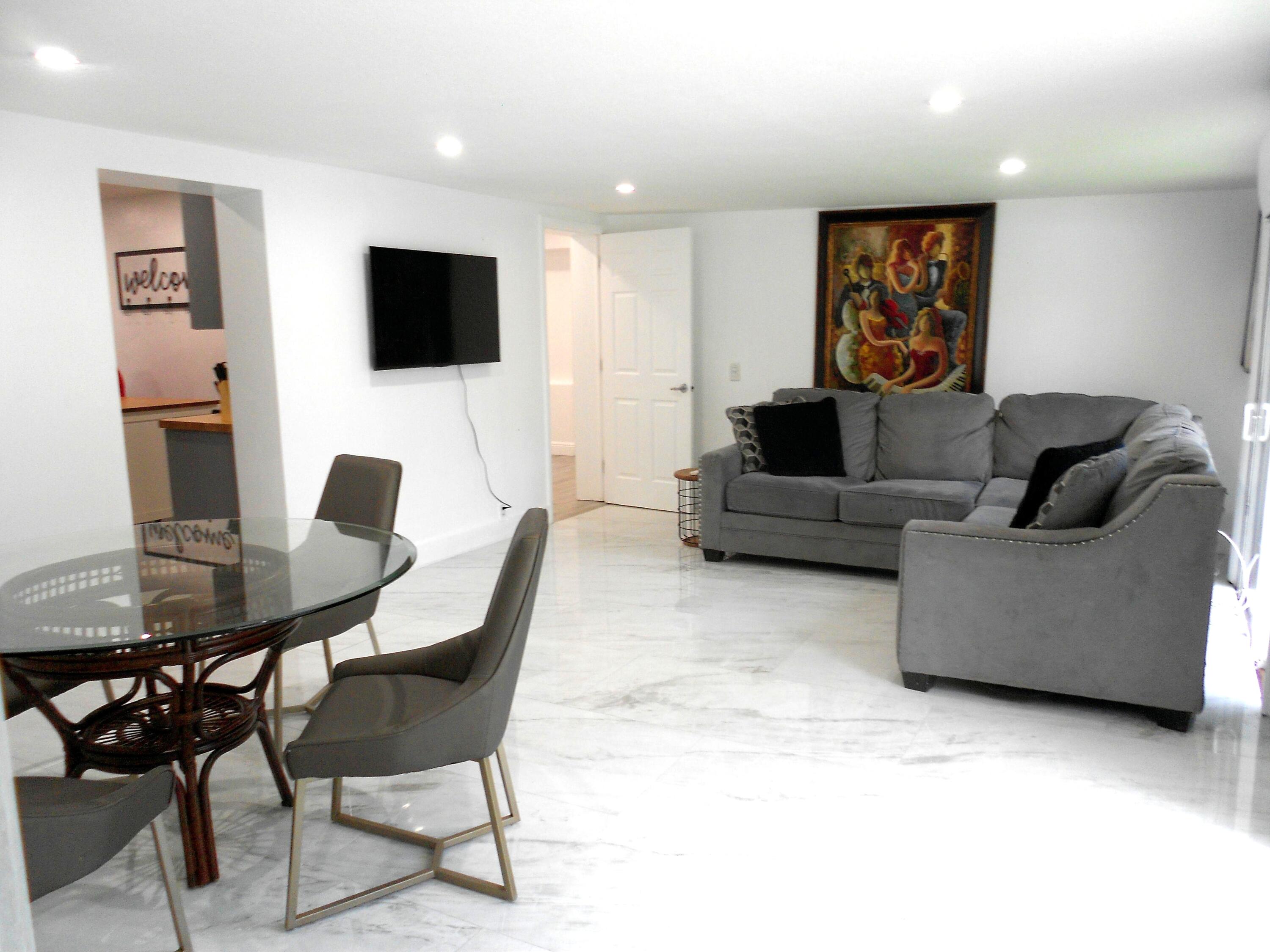 817 Northwest 30th Court Wilton Manors, FL 33311 - Photo 5 of 17 a living room with furniture and a flat screen tv