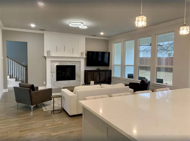 a large white kitchen with fireplace furniture and a window