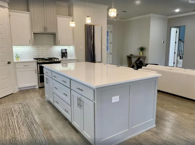 a large bed sitting in a bedroom next to a lamp