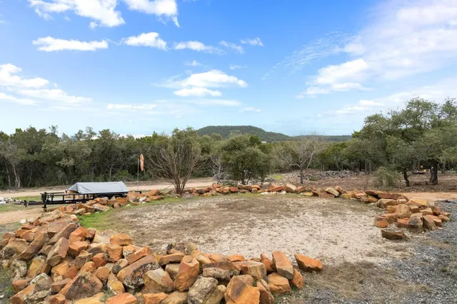 a view of a yard with wooden fence