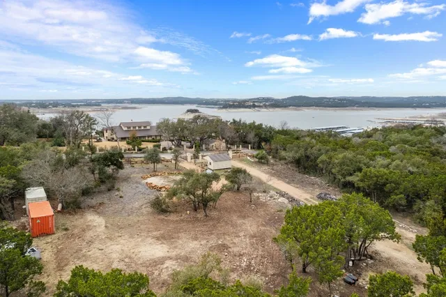 a view of a lake with beach and city view