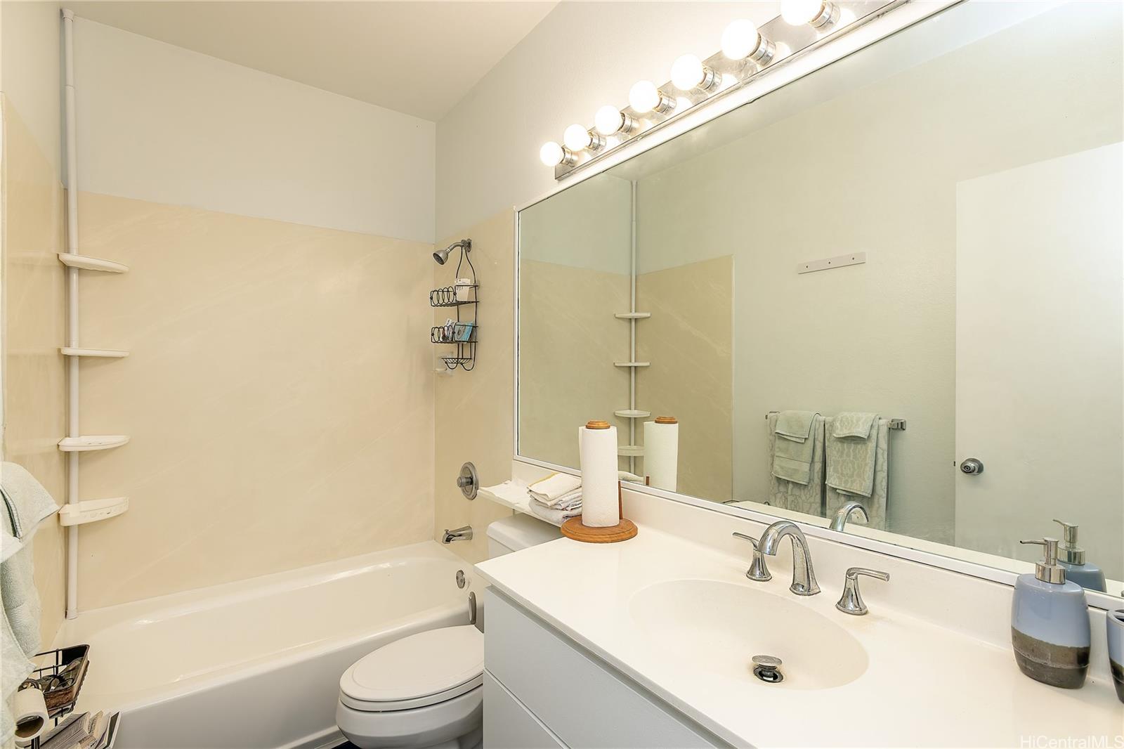 91-957 Laaulu Street, Unit 40F Ewa Beach, HI 96706 - Photo 15 of 22 a bathroom with a sink toilet and shower