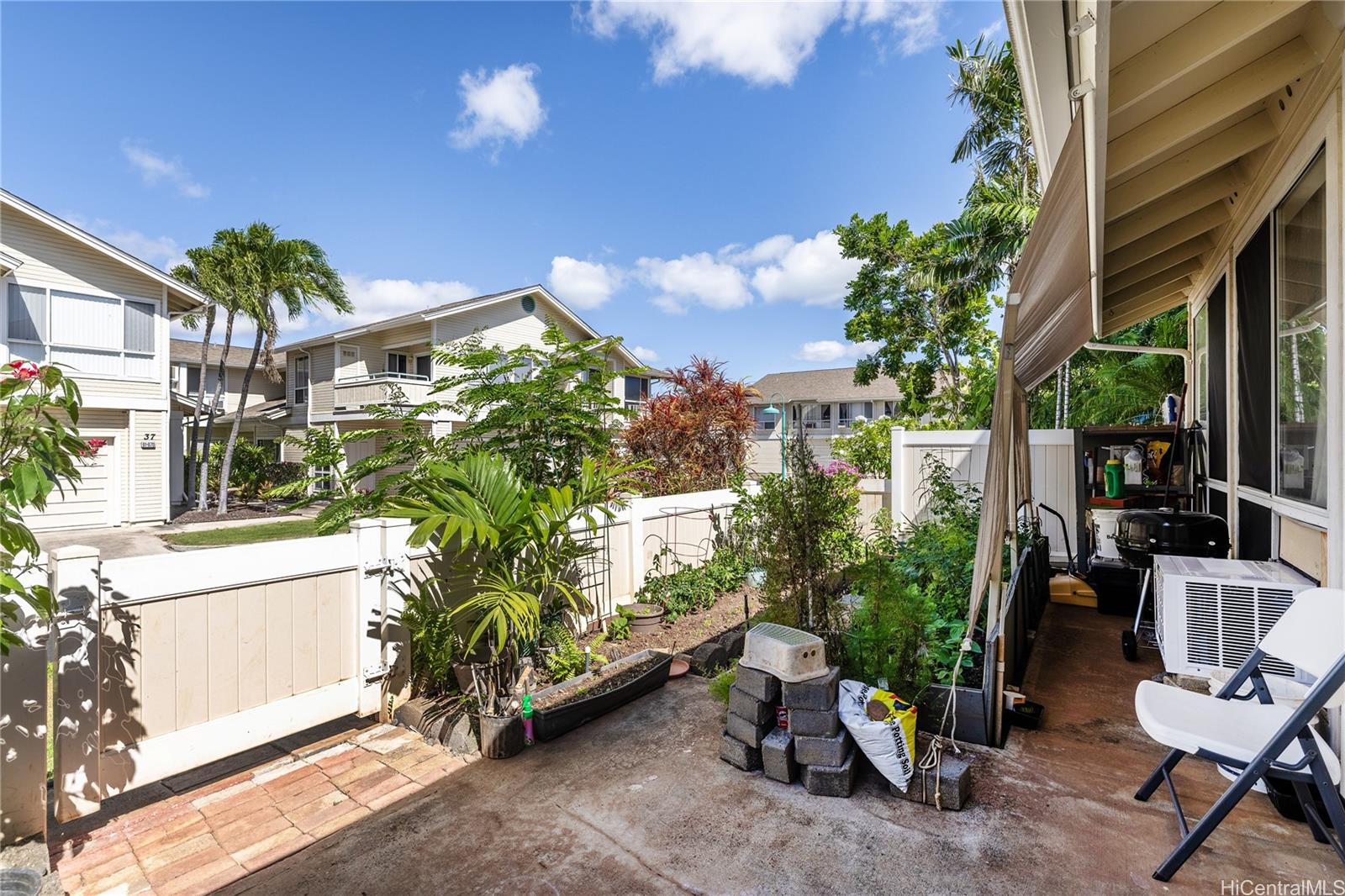 91-957 Laaulu Street, Unit 40F Ewa Beach, HI 96706 - Photo 17 of 22 a potted plant sitting in front of a house