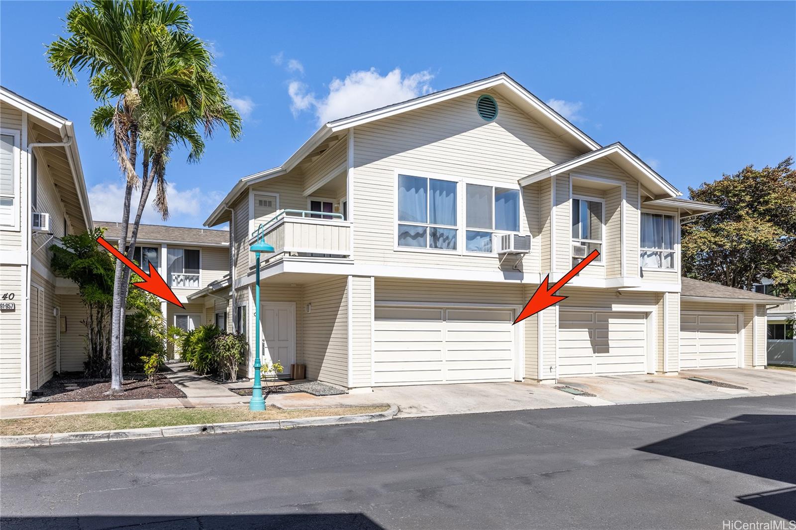 91-957 Laaulu Street, Unit 40F Ewa Beach, HI 96706 - Photo 19 of 22 a front view of a house with a yard and garage