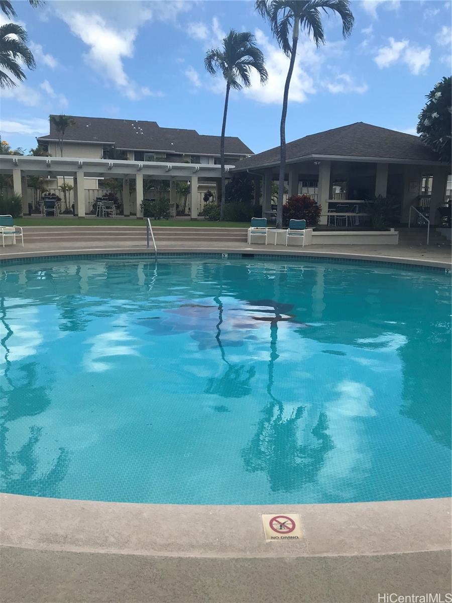 91-957 Laaulu Street, Unit 40F Ewa Beach, HI 96706 - Photo 21 of 22 a view of swimming pool with outdoor seating and lake view