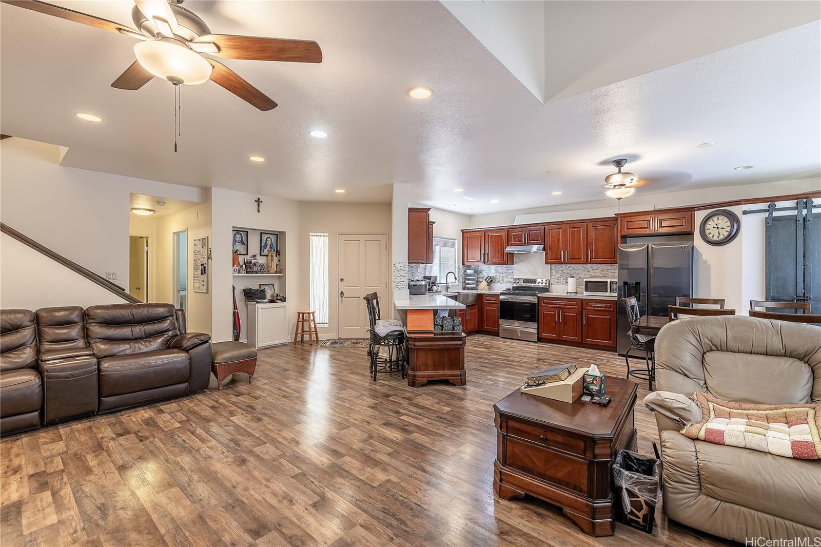 91-957 Laaulu Street, Unit 40F Ewa Beach, HI 96706 - Photo 3 of 22 a living room with furniture kitchen view and a chandelier