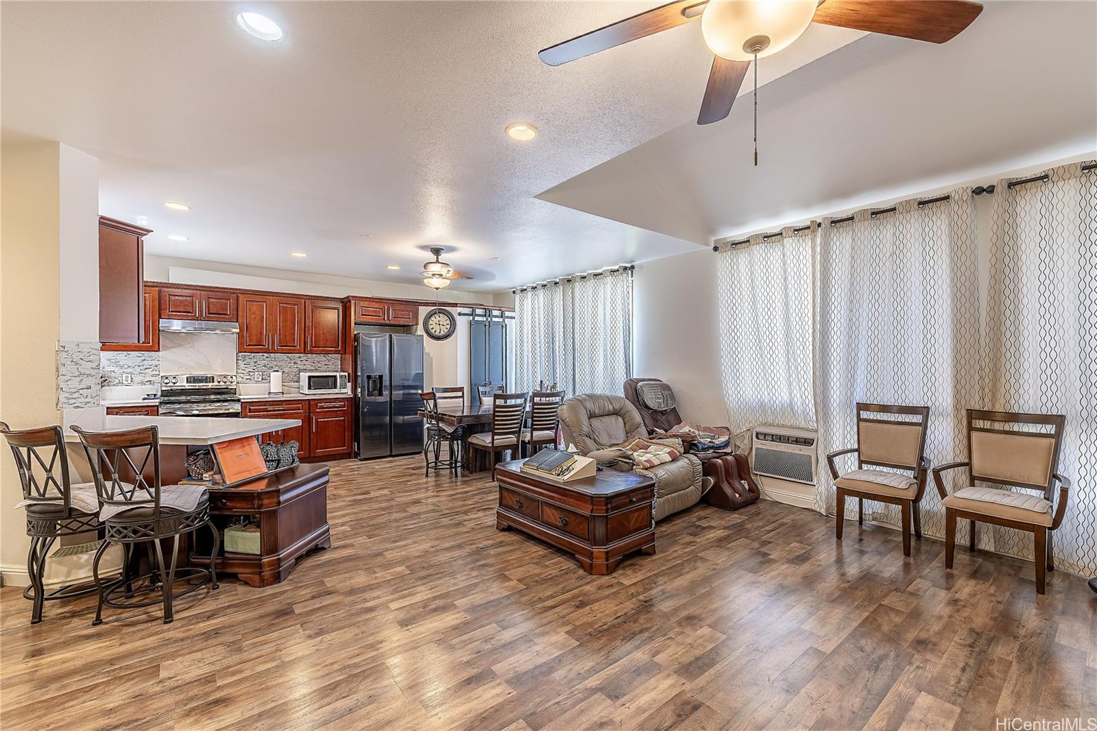 91-957 Laaulu Street, Unit 40F Ewa Beach, HI 96706 - Photo 4 of 22 a living room with lots of furniture and a wooden floor