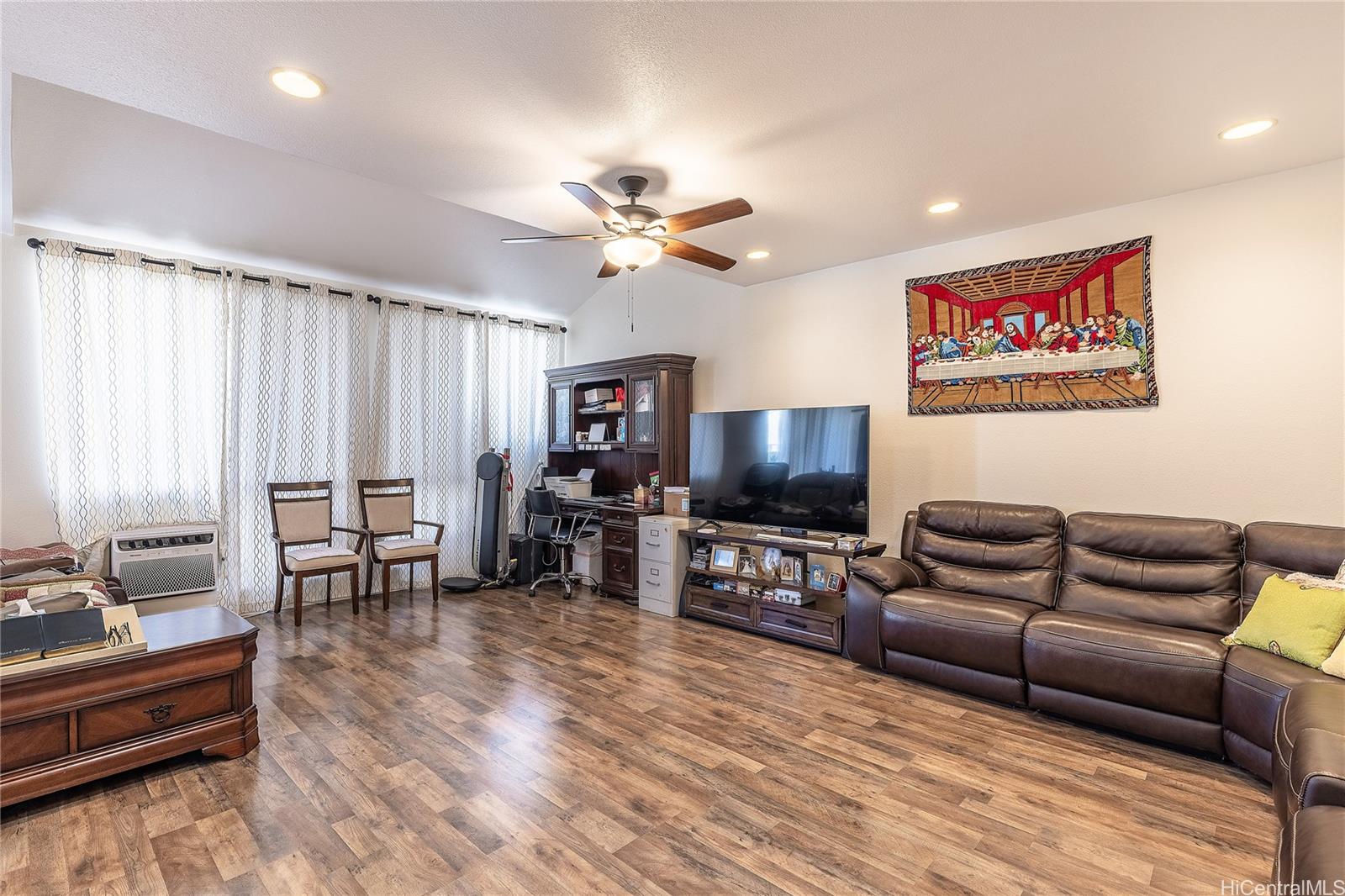 91-957 Laaulu Street, Unit 40F Ewa Beach, HI 96706 - Photo 5 of 22 a living room with furniture and a flat screen tv
