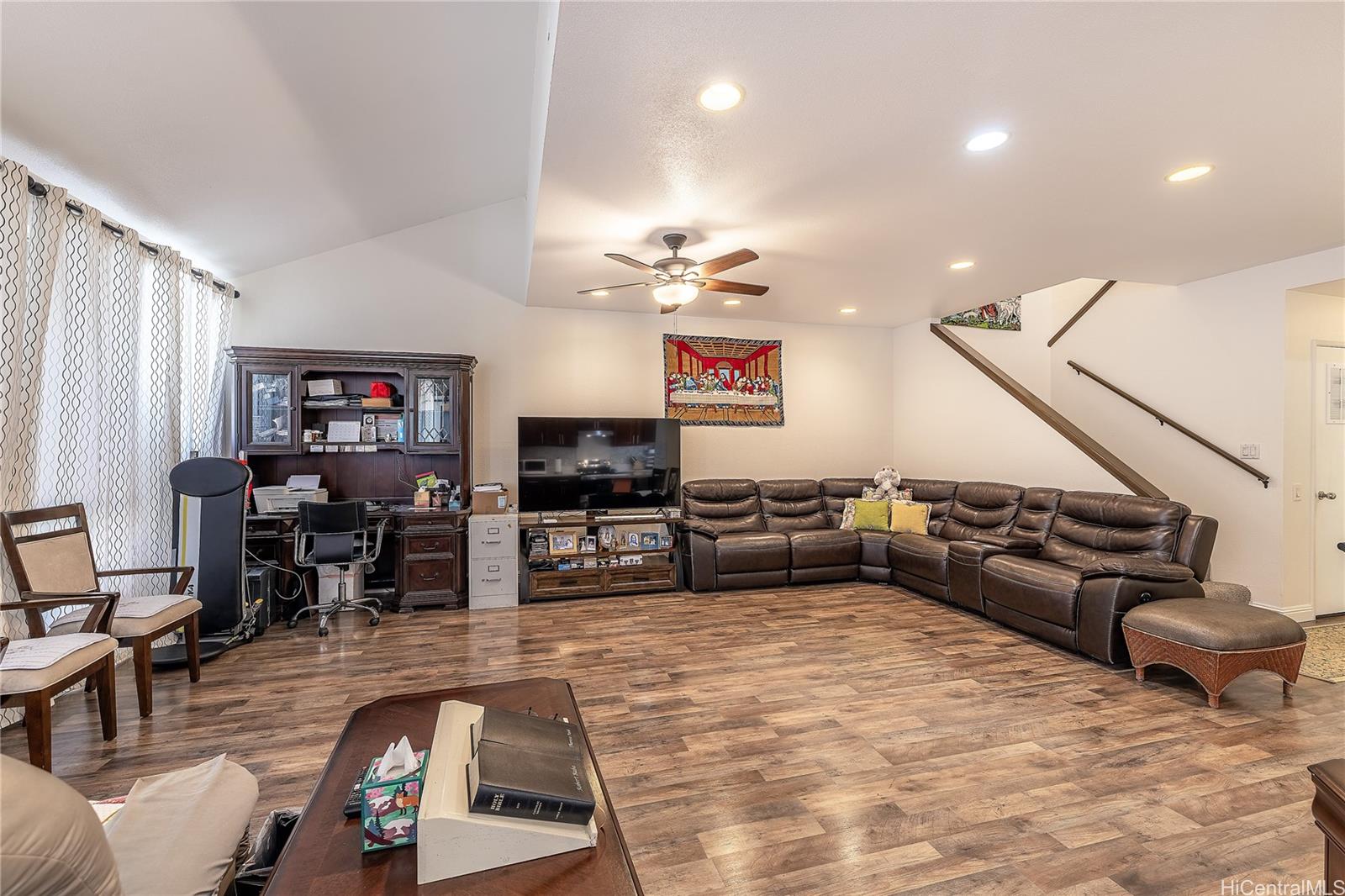91-957 Laaulu Street, Unit 40F Ewa Beach, HI 96706 - Photo 7 of 22 a living room with furniture and a flat screen tv with wooden floor