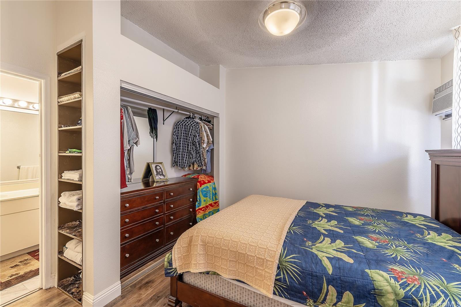 91-957 Laaulu Street, Unit 40F Ewa Beach, HI 96706 - Photo 8 of 22 a bedroom with a bed and a dresser