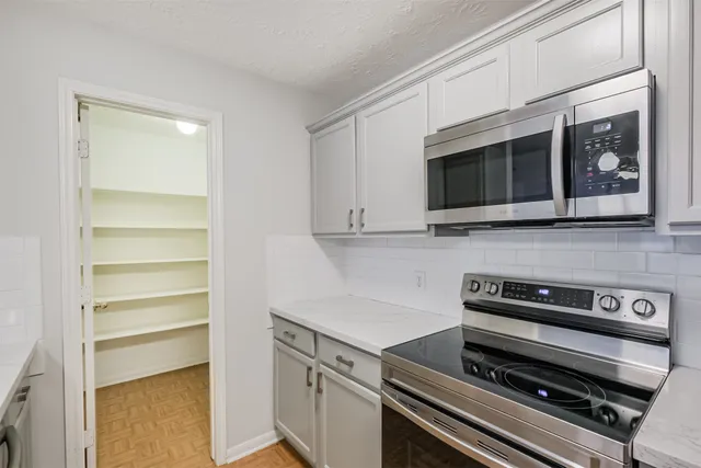 a kitchen with a microwave and cabinets