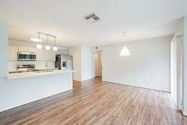 a view of kitchen with wooden floor and window
