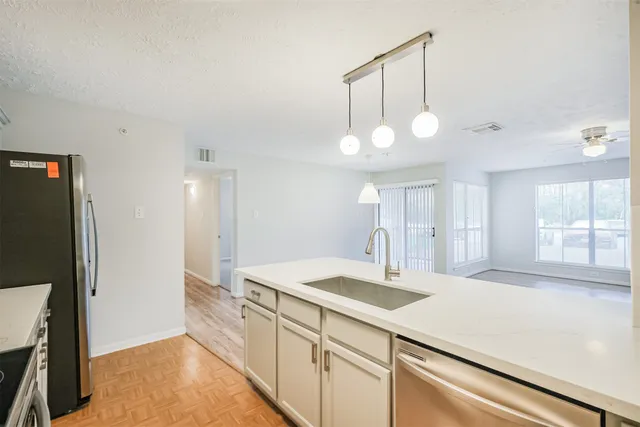 a kitchen with a sink and a refrigerator