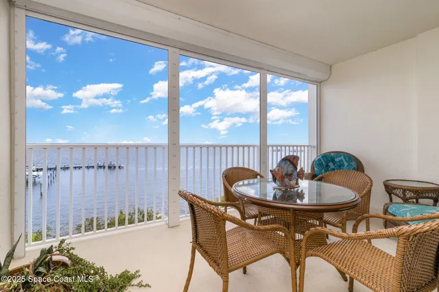 a dining room with furniture and a floor to ceiling window