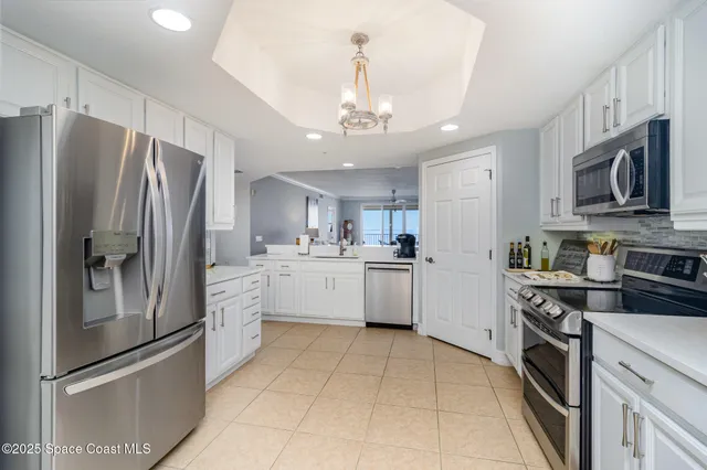 a kitchen with stainless steel appliances a refrigerator sink and microwave